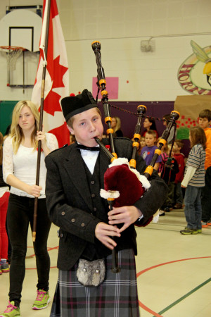 ZHPPS student Fraser Nagle pipes in the Color Party and Wreath Bearers.  Photo contributed by Anita Fraser.